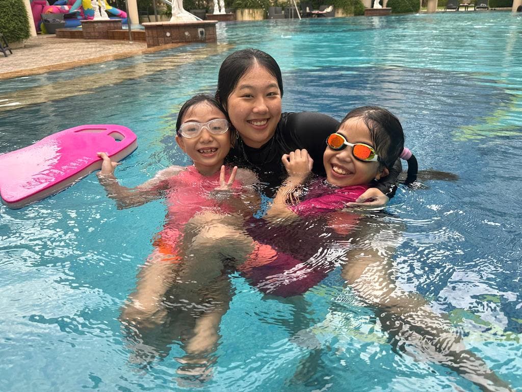Happy students with their swimming instructor after a successful lesson